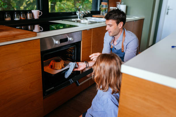 istock Father and son baking cake and bonding 1353495305