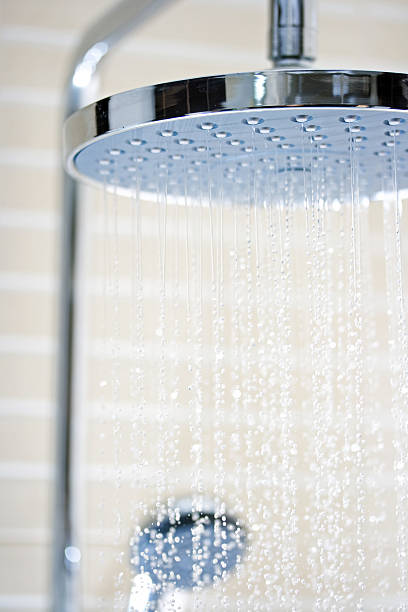 istock Chrome waterfall shower and light spray against blurred tile 135349581