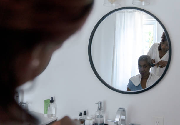 istock Mirror View of Shaving a Woman's Head 1353496552