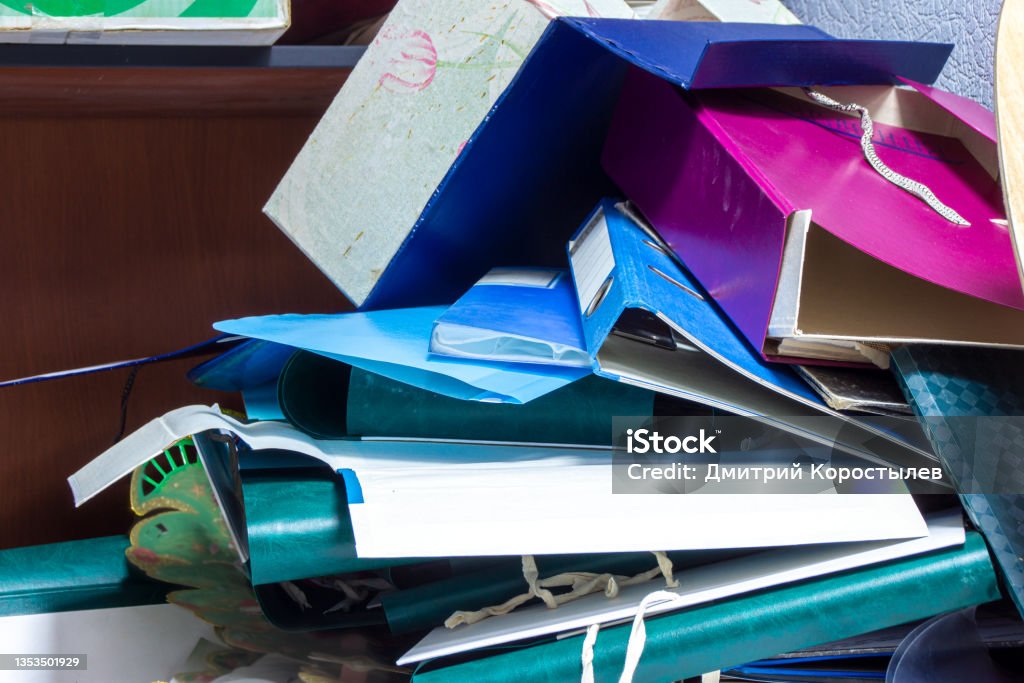 folders binder with documents in a mess lie on the shelf After old unnecessary documents were disposed of, old folders were piled up in a heap of binders for documents Chaos Stock Photo