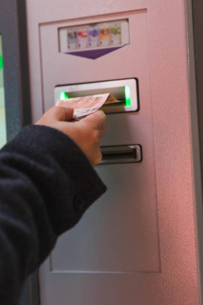 istock Male hand inserting money at electronic machine in parking 1353502012