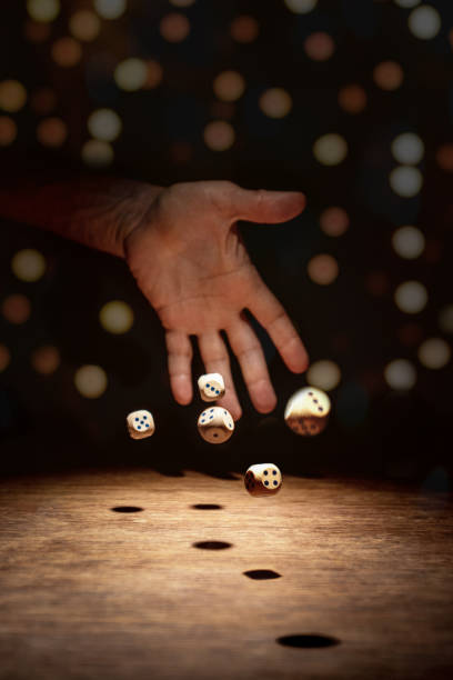 istock the dice thrown by the hand are scattered 1353502033