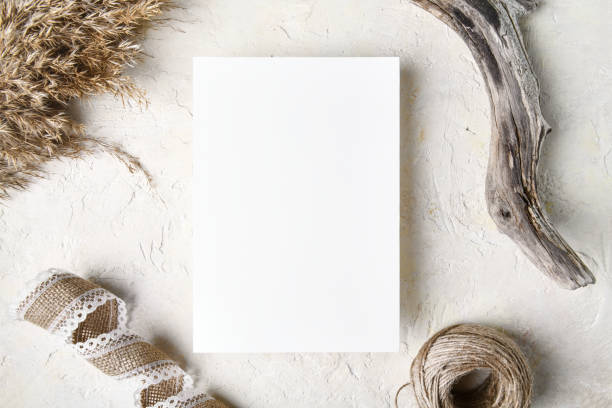 istock White invitation card mockup with a pampas grass decoration. 5x7 ratio 1353502085