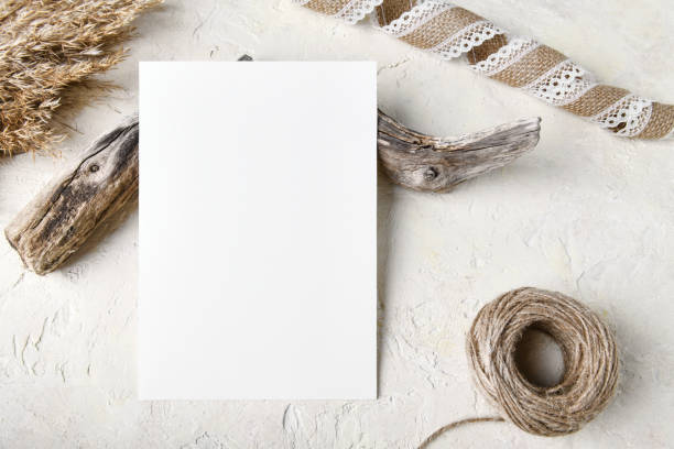 istock White invitation card mockup with a pampas grass decoration. 5x7 ratio 1353502086