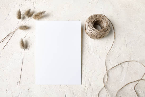 istock White invitation card mockup with a dry grass decoration. 5x7 ratio 1353502092