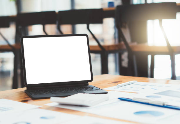 istock Laptop with blank screen on table. coffee shop blurred background. 1353504218