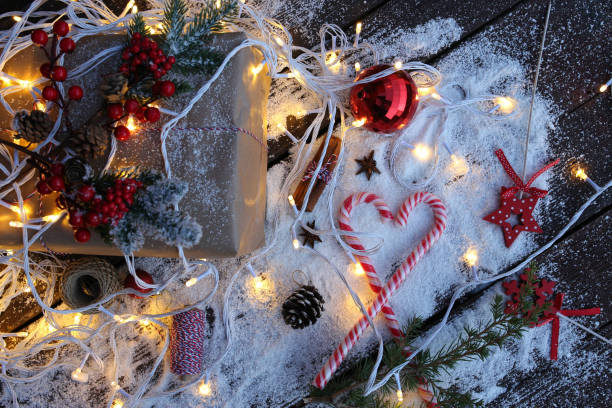 istock Rustic Christmas gift box with Christmas decorations on wooden background. Flatlay. Copy space stock photo 1353504590