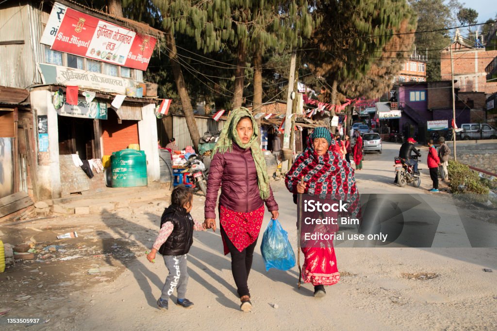 Street Scene in Nagarkot, Nepal Nagarkot, Nepal - 21 May, 2019 - Two women with a child walking on the street in Nagarkot, Nepalese ethnicity, Nepal. Adult Stock Photo