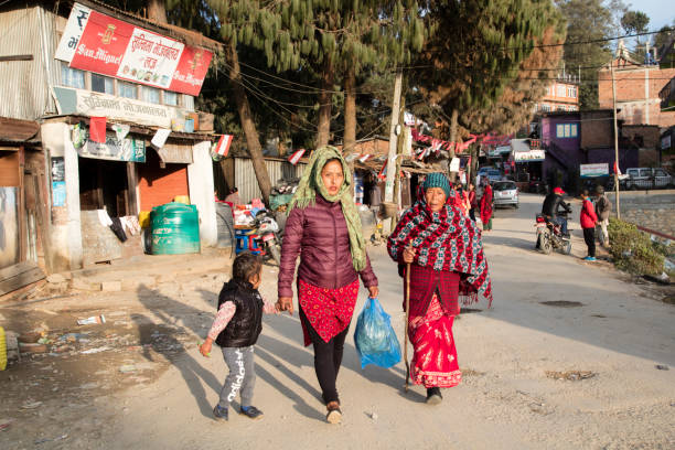 Street Scene in Nagarkot, Nepal Nagarkot, Nepal - 21 May, 2019 - Two women with a child walking on the street in Nagarkot, Nepalese ethnicity, Nepal. nagarkot photos stock pictures, royalty-free photos & images