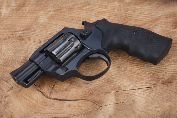 istock Cocked and locked revolver on wooden table 1353506048