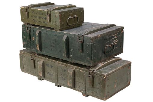 Soviet army ammunition stack of green crates. Text in russian - type of ammunition, projectile caliber, projectile type, number of pieces and weight. Isolated on white background.