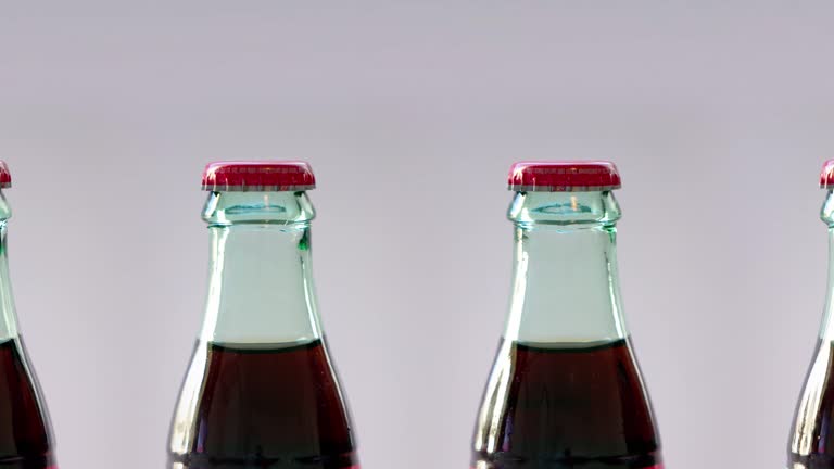 Panning of rotating bottles of a carbonated soft drink manufactured that contains water (often carbonated), a sweetener, and a natural and/or artificial flavoring.