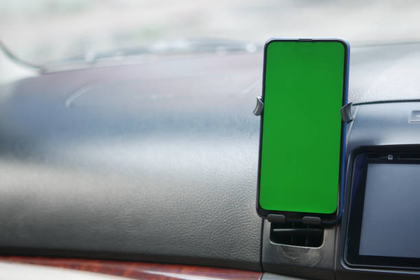istock smart phone with green screen on car dashboard 1353520221