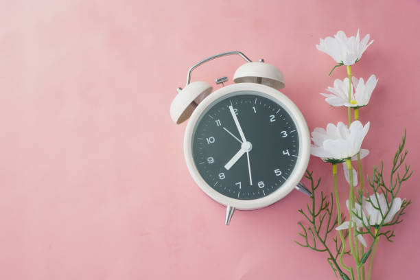 istock old alarm clock on wooden background. 1353520280