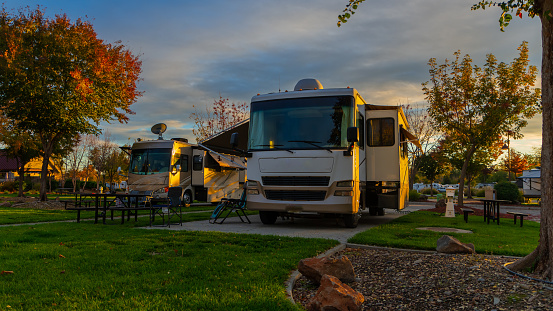 Motorhomes parked camping in the fall with tree changing colors and fall weather