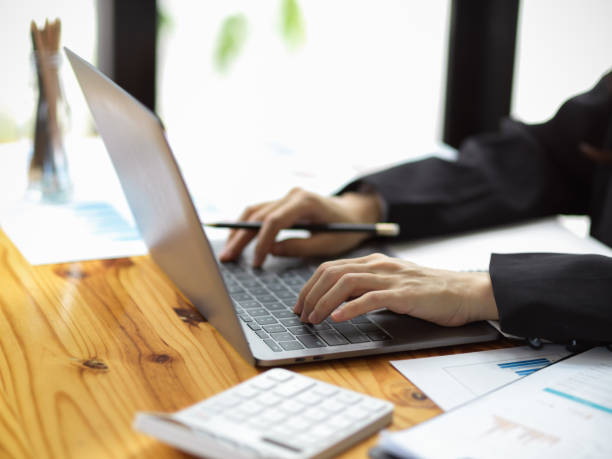 istock Cropped image of female accountant working on laptop computer 1353526598