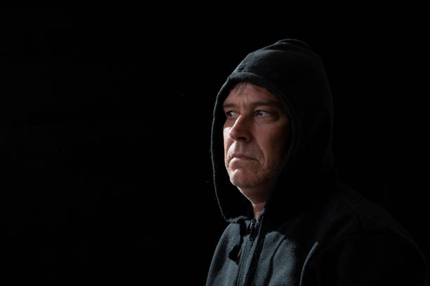 istock Middle aged man wearing a black hood 1353526857
