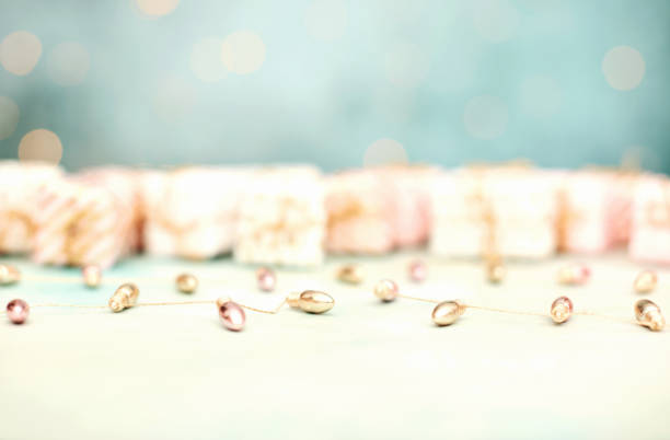 Christmas Background with Defocused Gifts and Metallic String Lights