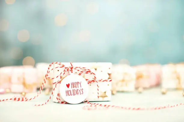 Photo of Bright Christmas Background with Happy Holidays Message on Christmas Gift