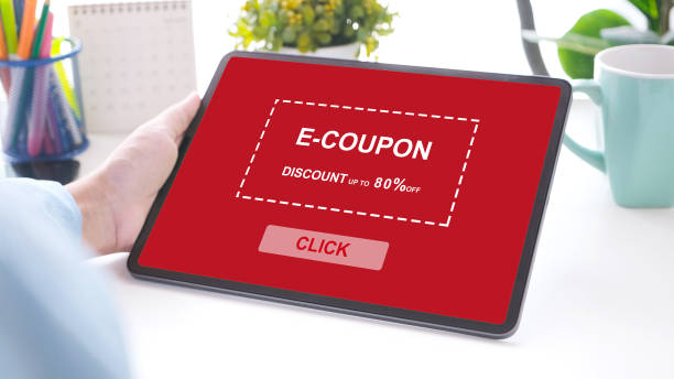 istock Hand holding digital tablet with discount coupon code on screen to get the shopping on line sale promotion, on line shopping ,digital marketing business and technology, lifestyle concept 1353528350
