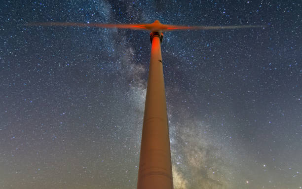 istock wind turbine at night with milky way 1353529400