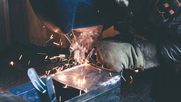 istock a man in his garage is welding metal 1353534317