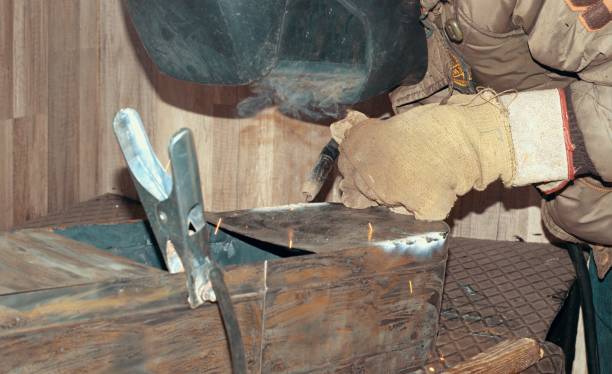 close up welder  welding  steel structure in construction site . welder put on leather gloves and helmet while worker welding protect electric and hot