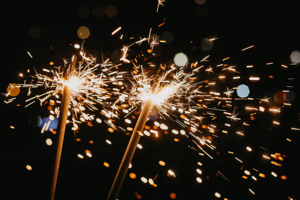 istock Bright glittering sparkler on blurred bokeh background 1353535311