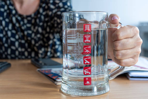 istock females hand with a glass cup with water 1353539917