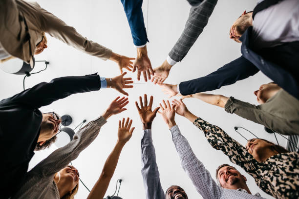 istock Low-angle shot of colleagues cheering at work 1353540128