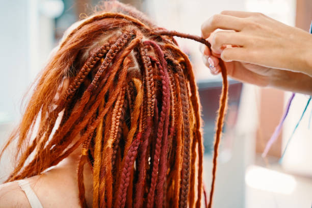 istock Braiding process african plaits with colored kanekalon. 1353544624
