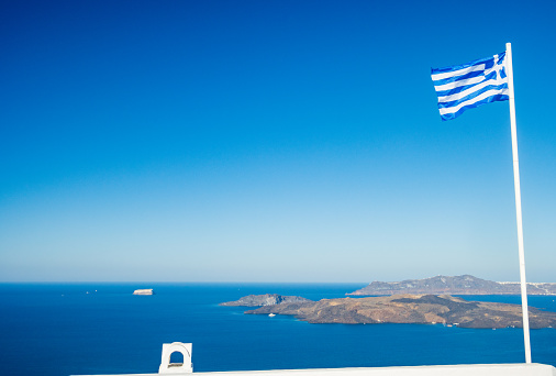 Greek Flag over Santorini Caldera on South Aegean Islands, Greece