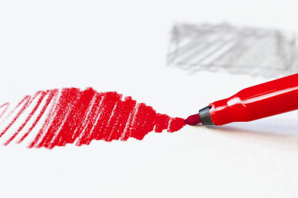istock Red felt tip pen draws on white paper 1353546707