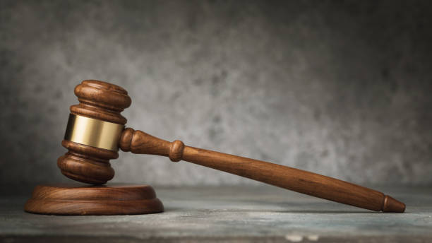 istock Wooden judge gavel on abstract background, close-up 1353547247