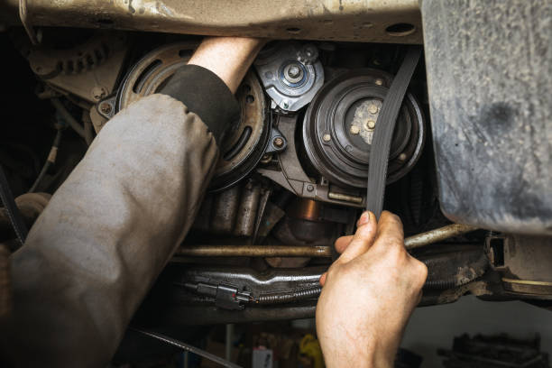 istock An auto mechanic installs a alternator belt in a passenger car engine 1353547968