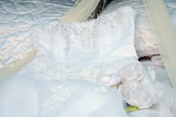istock A white wedding dress is spread on the bed sheet 1353548011