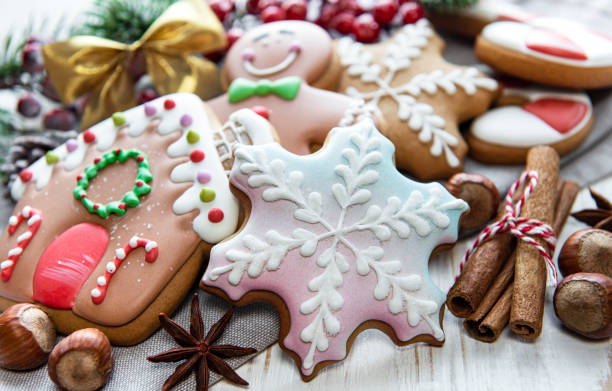 istock Christmas gingerbread with christmas decorations on white wooden 1353549500
