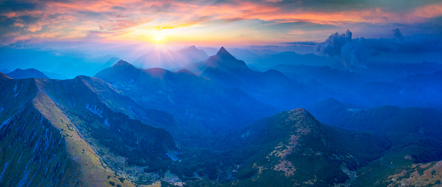 Drone view of foggy sunrise over in the fog, Hoverla is the Highest Mountain of Ukraine, Montenegrin ridge in the Carpathian mountains. Clouds after a thunderstorm.