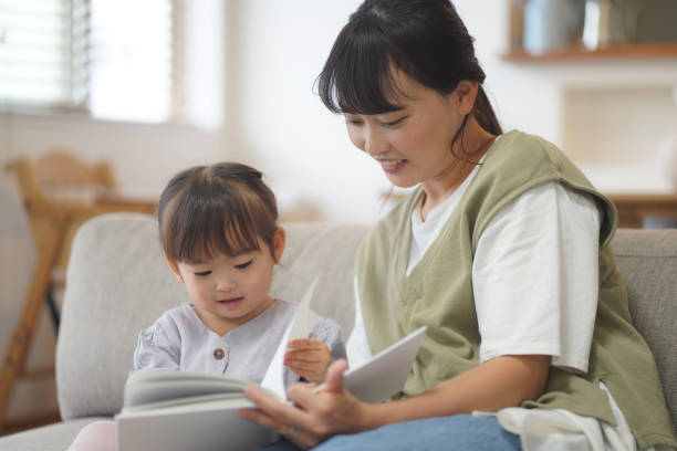 istock Parents and children reading picture books 1353552837