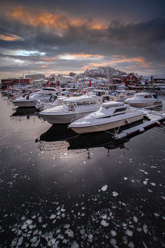 Boats in the harbour of Henningsvaer a fishing village located on several small islands off the southern coast of Austvagoya in the Lofoten archipelago in Norway.