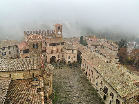 Italian medieval town Castell'Arquato,  province of Piacenza, in Emilia-Romagna. Foggy autumn day. Telephone shoot.