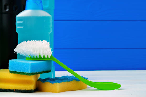 istock Various cleaning items against blue wooden background 1353555528