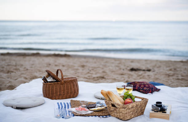istock Beach picnic with schripms, beer, fruit and candles 1353556853