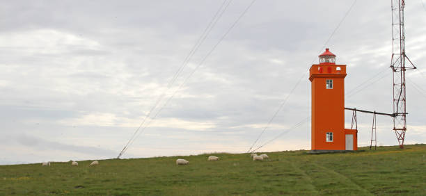 Red lighthouse on the cliff in north-Iceland