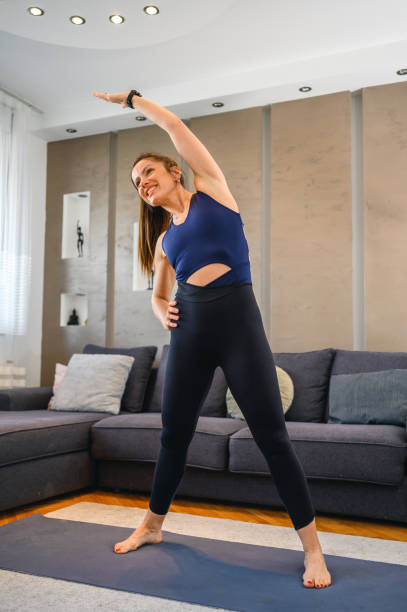 istock Woman exercising at home 1353557889