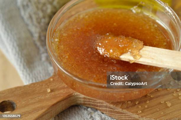 Closeup Of Homemade Lip Scrub Made Out Of Brown Sugar Honey And Olive Oil In Glass Bowl On Wooden Chopping Board Natural Beauty Product Stock Photo - Download Image Now