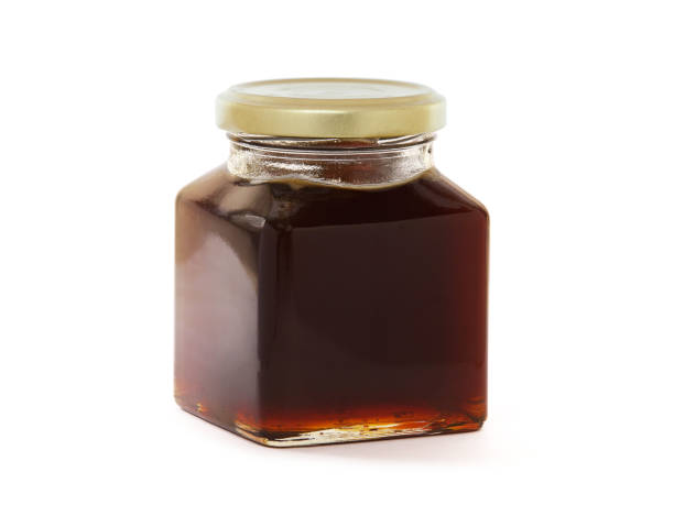 istock Jar of black forest honey isolated on white 1353560578