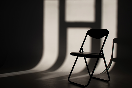 Black office chair and shadows on white background
