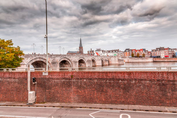 Maastricht, Holland - October 16, 2021: Sint Servaasbrug or the St. Servatius Bridge is an arched stone footbridge across the Meuse River in Maastricht, Netherlands. It is named after Saint Servatius, the first bishop of Maastricht.