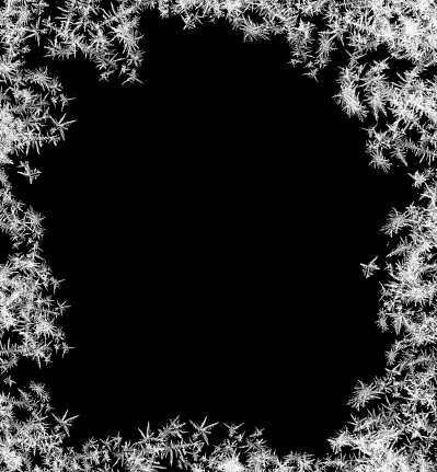 A frame of a frosty pattern of ice crystals on a black background. A frame with an abstract ice structure allows you to apply or add a frost effect. Frost on the glass, freezing effect